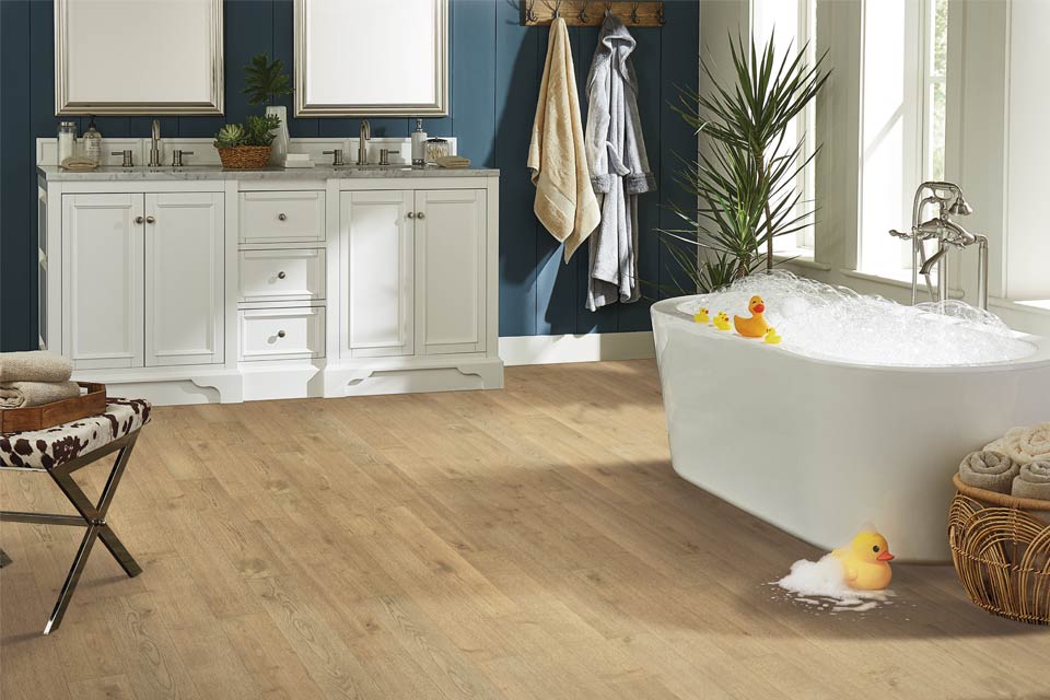 vinyl plank flooring in bathroom with bathtub.